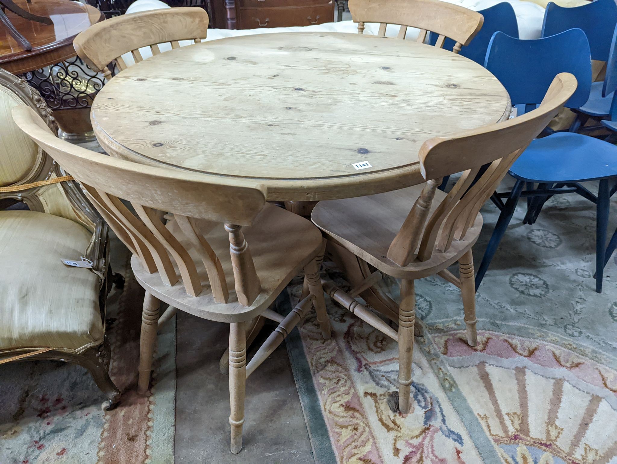 A Victorian style circular pine breakfast table, diameter 105cm, height 74cm, together with four Victorian style beech lathe back kitchen chairs